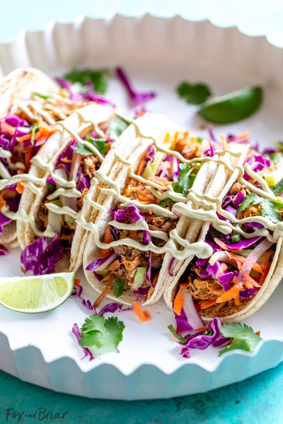 Slow cooker Mexican Pulled Pork Tacos with jicama topping and avocado crema